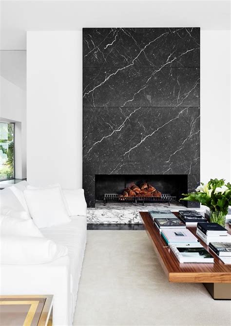 A Monochrome Living Room With A Marble Fireplace Contemporary