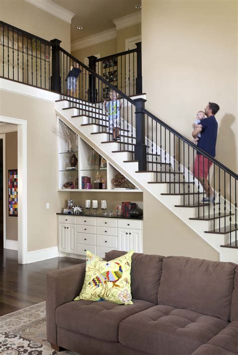A Living Room Filled With Furniture And A Stair Case