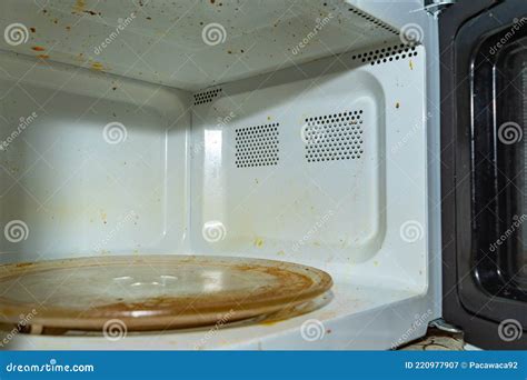 Dirty Microwave Oven With Burnt Paint On The Walls And Traces Of