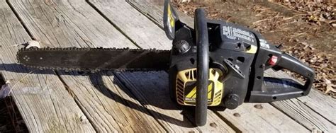 A Chainsaw Sitting On Top Of A Wooden Table Next To A Leaf Filled Park