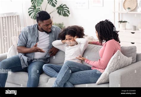 Annoyed Black Parents Scolding Stubborn Little Daughter At Home Stock