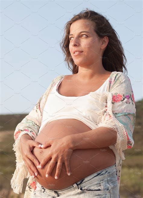 Pregnant Woman On The Beach Containing Pregnant Woman And Young