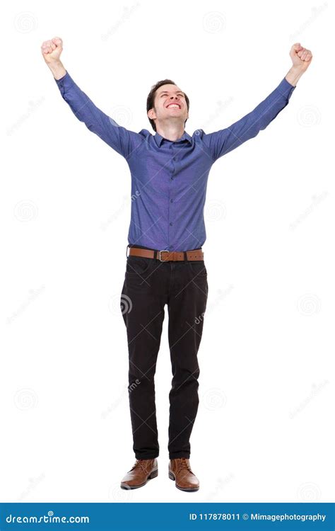 Full Length Carefree Young Man Standing With Arms Outstretched In Joy