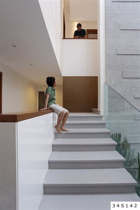 A Person Sitting On Some Stairs In A House