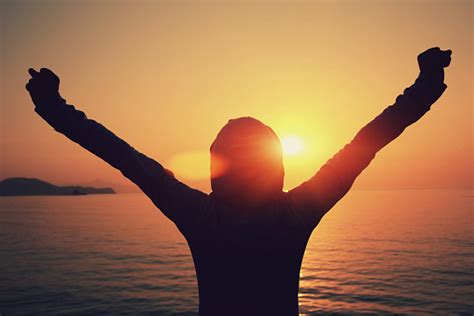 Strong Confident Woman Open Arms To Sunrise At Sea Stock Photo