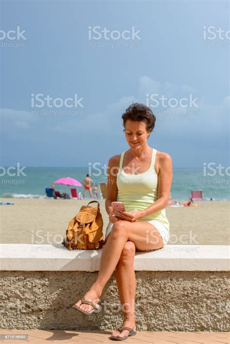 Mature Beautiful Tourist Woman Getting Away From It All At The Beach