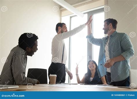 Excited Male Employees Give High Five At Briefing Stock Image Image