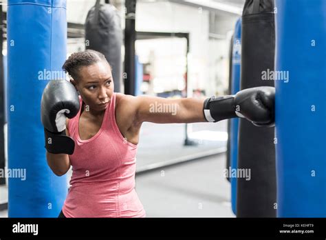 Black Woman Wearing Boxing Gloves Hitting Punching Bag Stock Photo Alamy