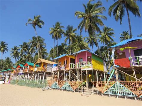 Many Colorful Houses On The Beach With Palm Trees In The Background