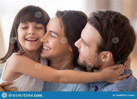 Kid cute mom and dad. Cute Little Girl Hug Mom And Dad Showing Love Stock Photo ...