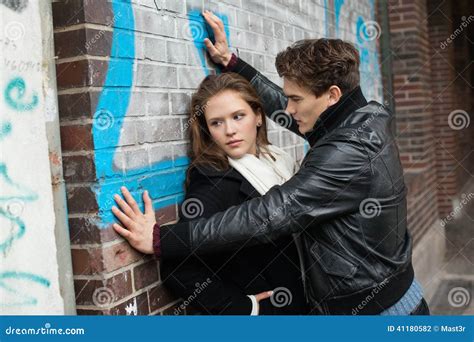 Man Looking At Woman Leaning On Wall Stock Photo Image Of Scarf