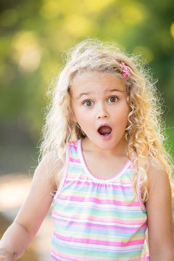 Girl Standing Outside Making A Surprised Face At Camera Stock Photo