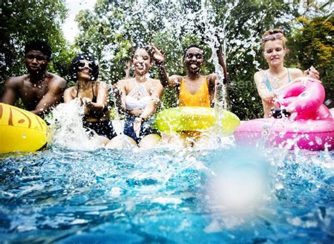 Group Of Diverse Friends Splashing Water At The Swimming Pool Pool Splash Pool Pool Photos