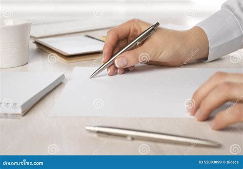 Closeup Of Business Woman Hand Writing On Paper At Desk Stock Image