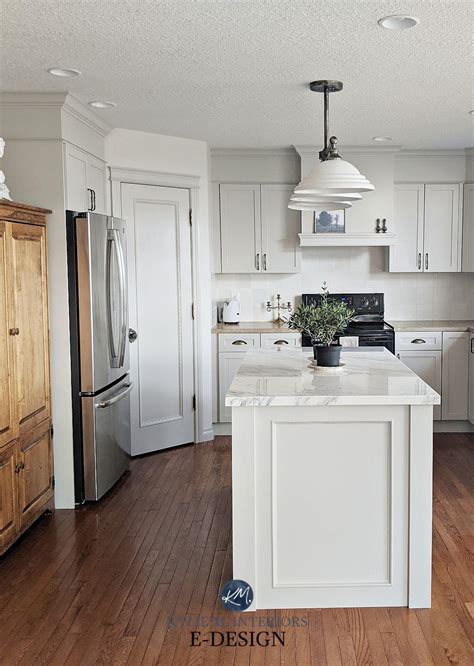 What whites go with agreeable gray. Gray greige painted kitchen maple cabinets. Marble island ...