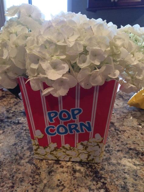 Movie Night Centerpiece With Popcorn Container And White Hydrangeas