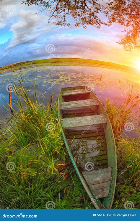 A Picturesque Landscape With A Boat In Reeds On The Lake On Suns Stock