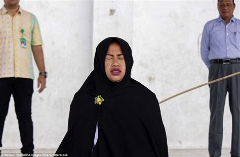 suspected prostitutes caned during mass flogging that leaves man s back red raw in indonesia