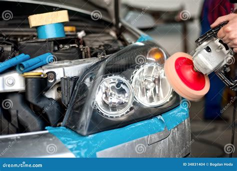 Auto Mechanic Working On Polishing A Car Headlight Stock Photo Image