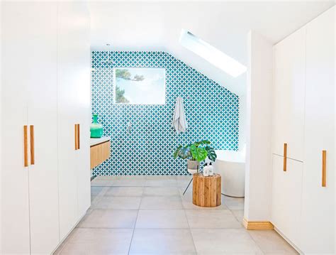This White And Wood Bathroom Has A Bright Blue Accent Wall To Liven It