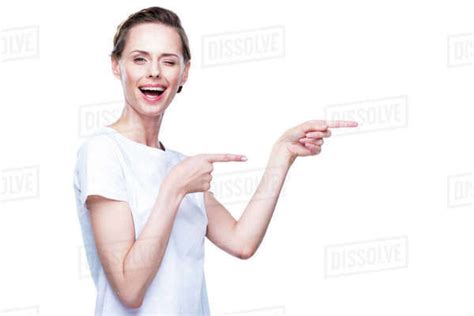Beautiful Winking Woman In White T Shirt Pointing Somewhere Isolated