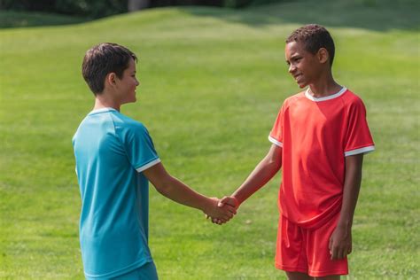 Happy Multicultural Kids Shaking Hands Outside Free Stock Photo And Image