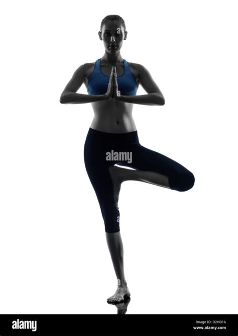 One Woman Exercising Yoga Tree Pose Vrksasana In Silhouette Studio