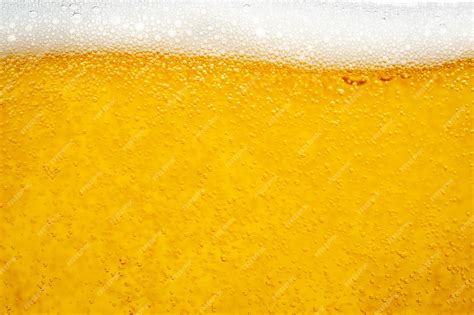 Premium Photo Pouring Beer With Bubble Froth In Glass For Background