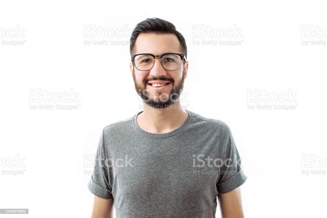 Portrait Of Brooding Bearded Man In Grey Tshirt Looking Up And Putting