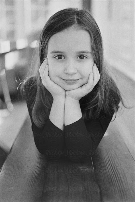 Black And White Portrait Of A Cute Young Girl Laying On A Bench Del