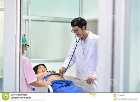 Doctor Nurse Examining Pregnant Woman With Stethoscope Stock Photo