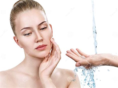 Woman Face And Pouring Water In Hand Moistening Concept Stock Image