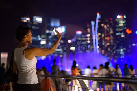 Happy Mature Beautiful Tourist Woman Taking Selfie In The City At Night