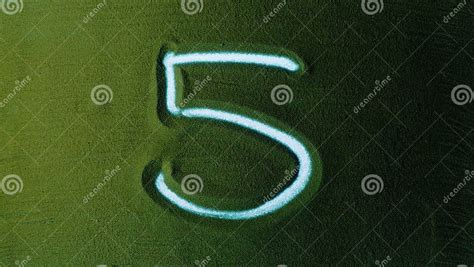 Hand Drawing Number Five 5 Symbol In The Green Sand Stock Image