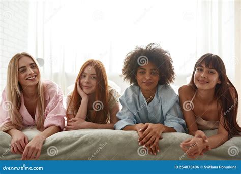Group Of Smiling Multiethnic Girls Lying On Bed Stock Photo Image Of Smiling Smile