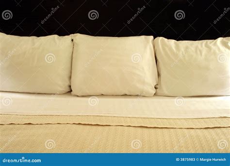 Three Pillows On A Bed Stock Image Image Of Beige Pillows