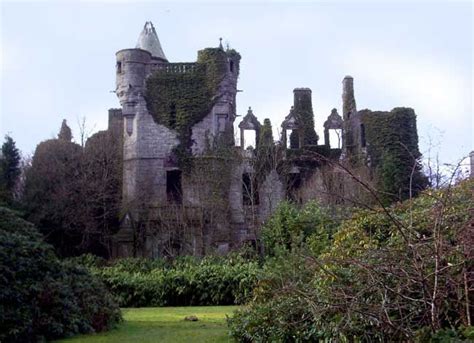An Old Castle Is Surrounded By Trees And Bushes