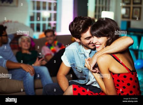 Couple Hugging In Living Room At Party Stock Photo Alamy