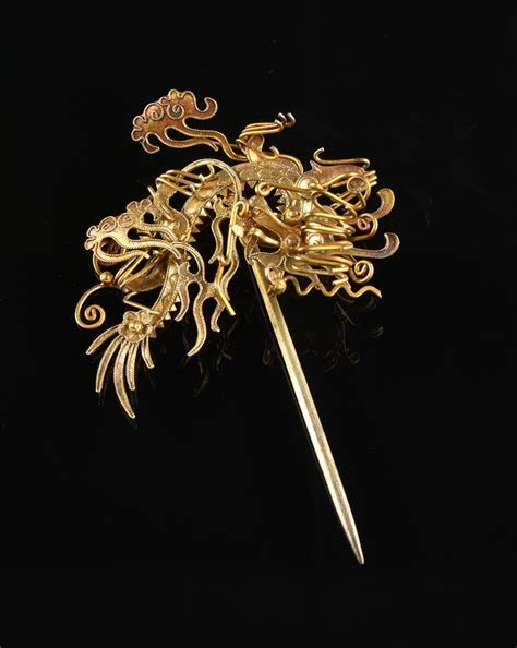 A Pair Of Chinese Hair Pins 20th Century Each A Highly Stylized Dragon Figure With Scrolling