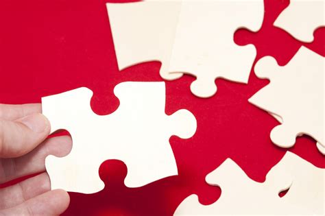 Click on the picture you like to cast your vote. Image of Assembling Blank Puzzle Pieces on Red Surface ...