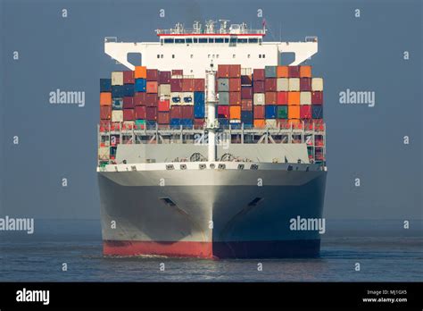 Front View Of A Large Shipping Container Ship In The Ocean Stock Photo