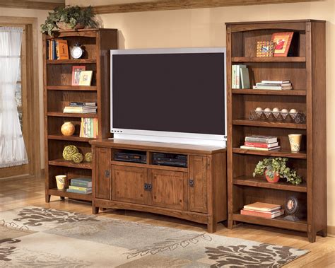 Inspired by the sheer simplicity and weatherworn beauty of primitive furniture, this tv stand brings a relaxed sense of style into your space. Ashley Furniture Cross Island 60 Inch Oak TV Stand with ...