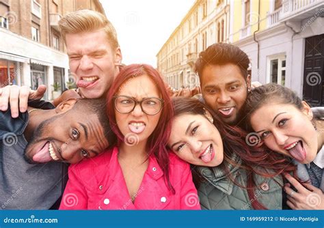 Multiracial Best Friends Taking Selfie Outdoors In Urban Contest