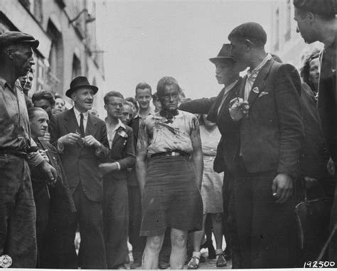 Civilians And Members Of The French Resistance Lead A Female Collaborator Through The Streets Of