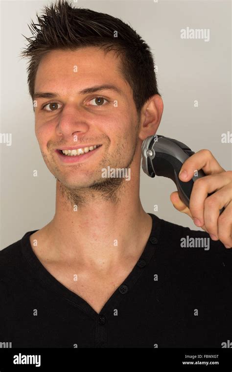 Man Shaving Face With Electric Razor Stock Photo Alamy