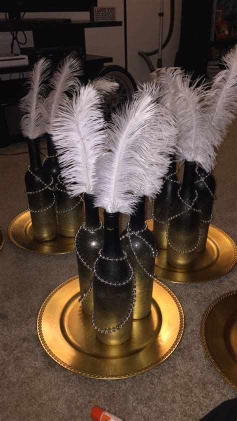 Great Gatsby inspired centerpiece. Wine bottles with ombre color atop a