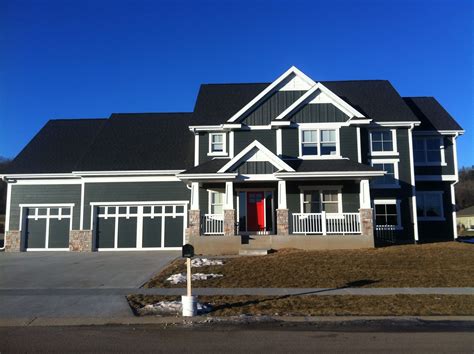 The best time to paint is before the installation. James Hardie board siding (gray), white trim, red door ...