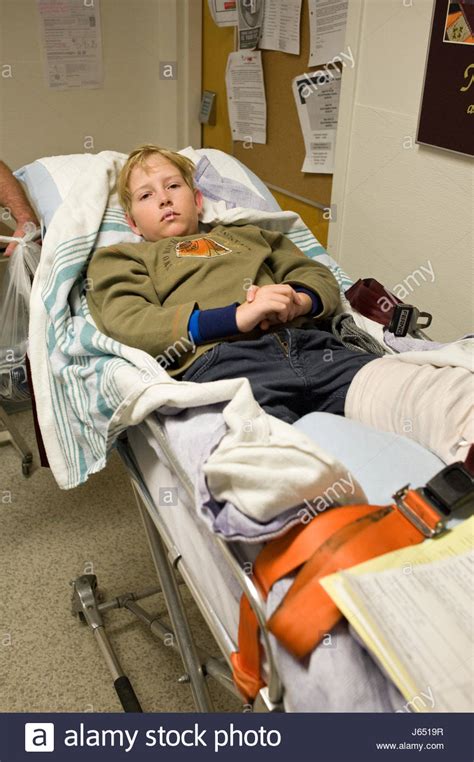 Eleven Year Old Boy With A Broken Leg Lying On Hospital Gurney Before