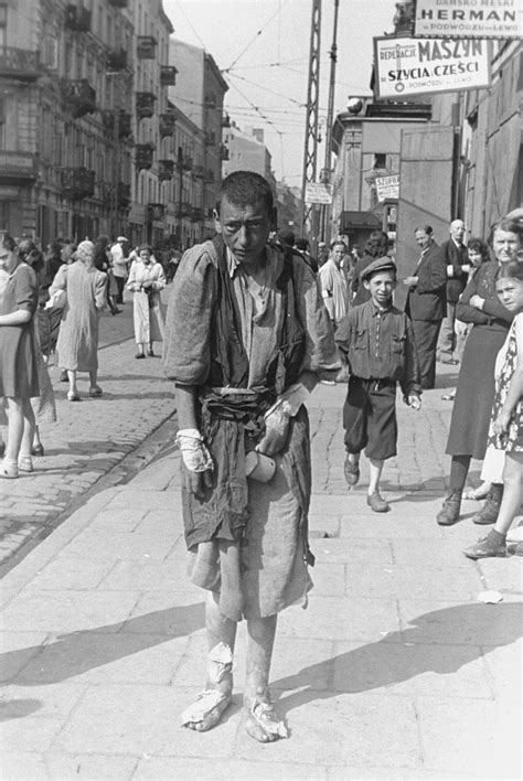 A Bandaged Destitute Jewish Youth Walks Along A Street In The Warsaw