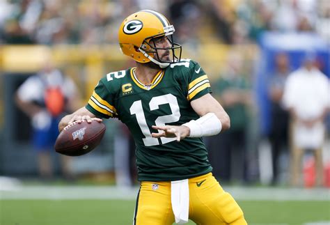 — 16/21 — 3 td. Aaron Rodgers is wearing a playcalling wristband for the ...